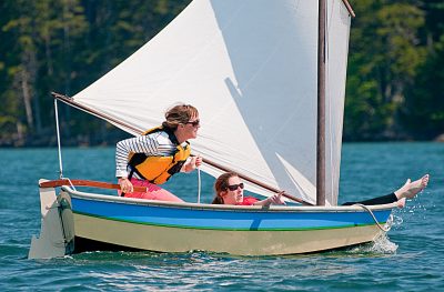 A Nutshell Pram dinghy being sailed, one of the world's best dinghies