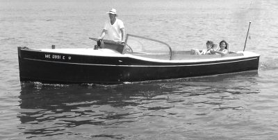 Havalah Hawkins, Jr. at the wheel of GRAMP in the 1980s before the boat went to Coecles Harbor. - Mystic Seaport Watercraft Collection